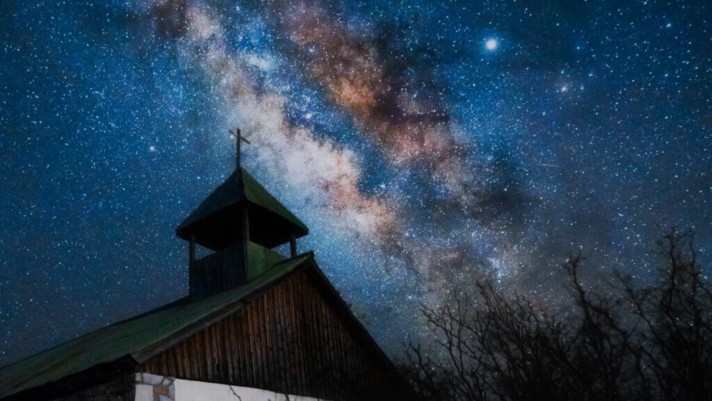 Church at night with blazing stars in milky way