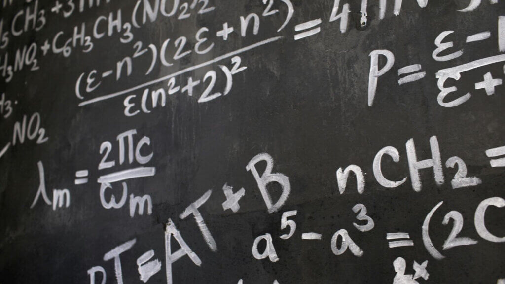 Lots of equations on a chalkboard