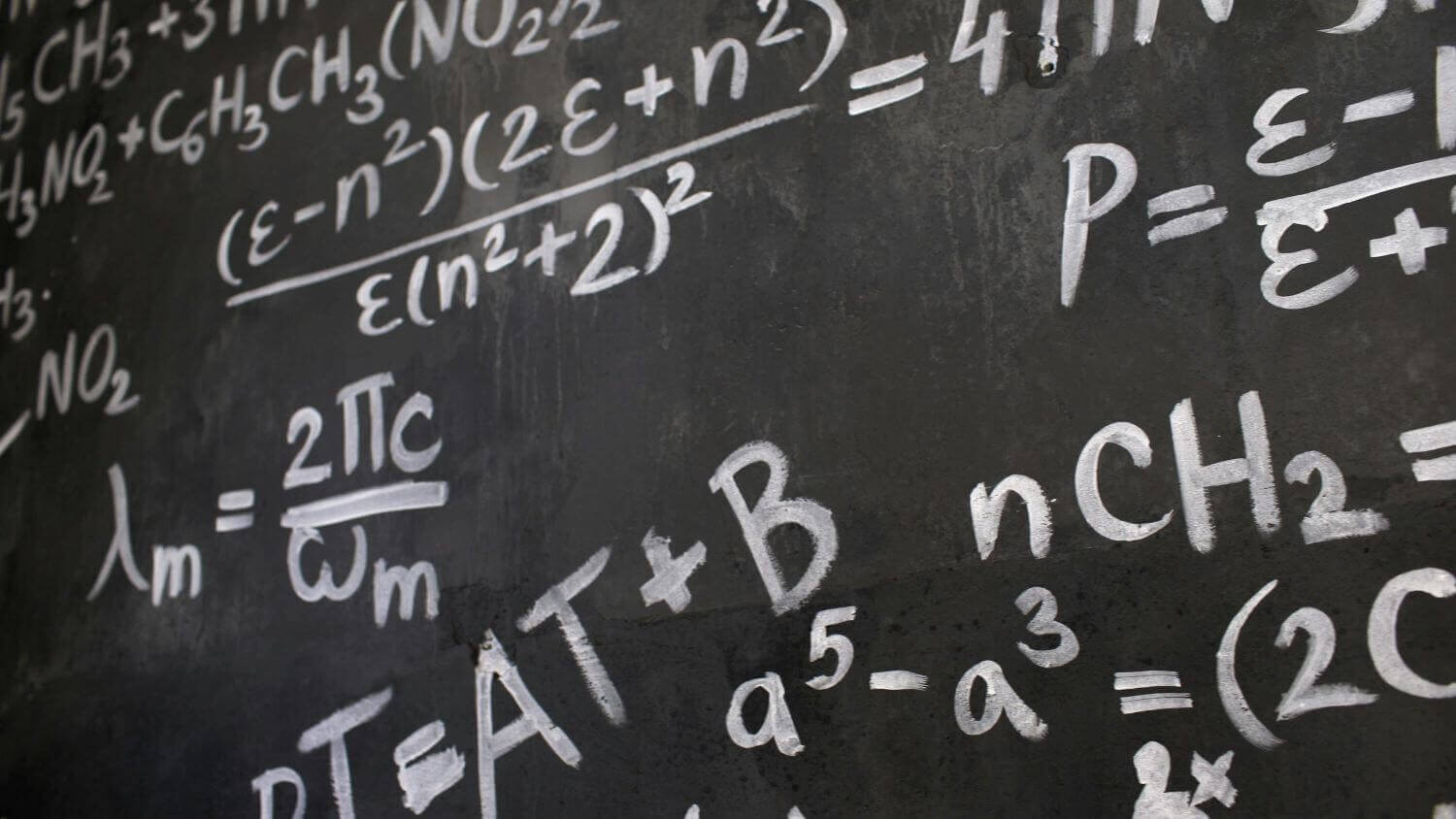 Lots of equations on a chalkboard